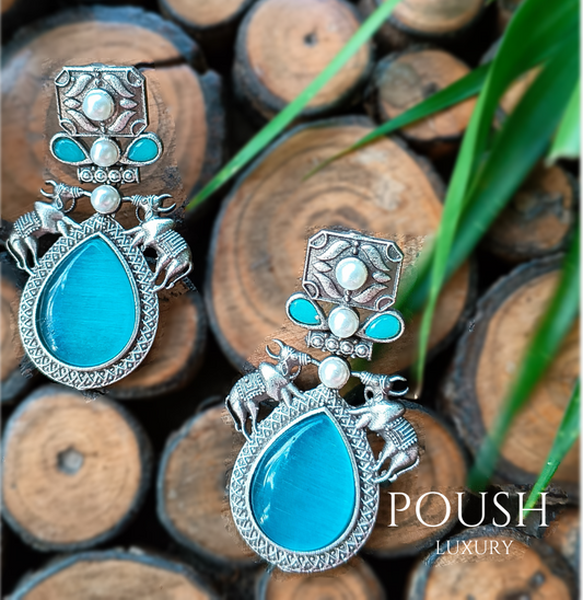 POUSH LUXURY Brass Stone Studded Bull Silver Looking Firozi Dangler Earrings